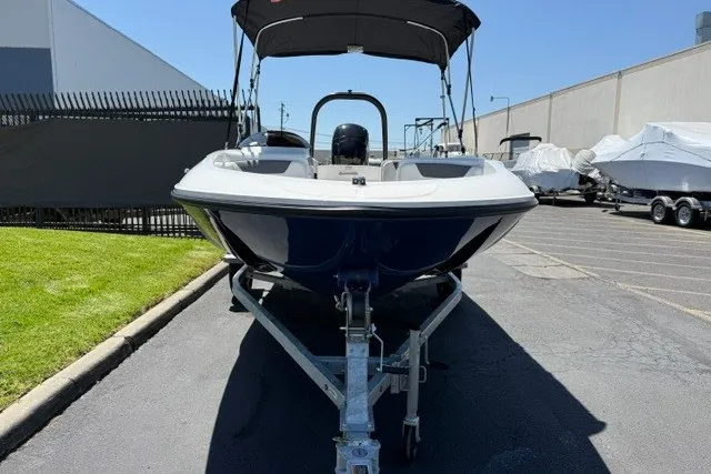 Slide: The Image of 2027 Bayliner Element E16 boat on trailer, parked outdoors. - 19