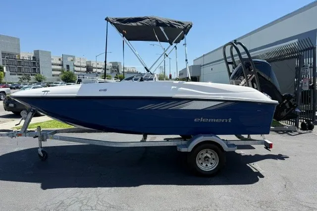 Slide: The Image of 2027 Bayliner Element E16 boat on trailer, blue hull, parked outdoors. - 13