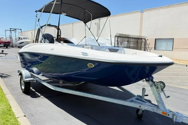 Slide: The Image of 2027 Bayliner Element E16 boat on trailer, parked outdoors with canopy. - 8