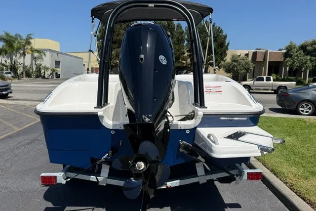 Slide: The Image of 2027 Bayliner Element E16 boat, rear view with outboard motor, parked outdoors. - 17