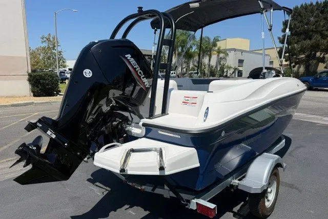 Slide: The Image of 2027 Bayliner Element E16 boat with Mercury engine on trailer, parked outdoors. - 10