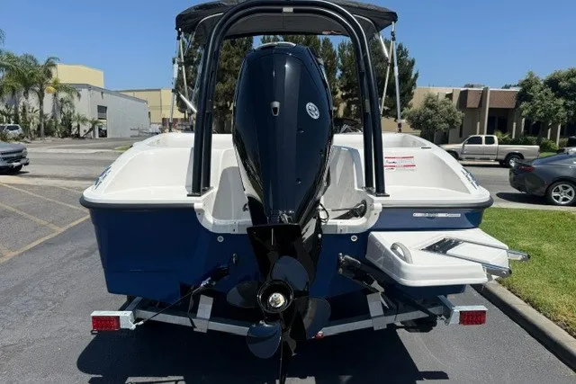 Slide: The Image of 2027 Bayliner Element E16 boat with outboard motor, parked on a trailer in a lot. - 11