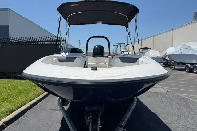 Slide: The Image of 2027 Bayliner Element E16 boat with canopy, parked outdoors on a sunny day. - 14