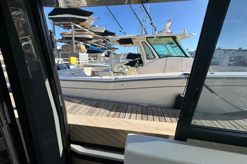 Slide: The Image of 2027 Saxdor 400 GTC yacht docked at marina, viewed from interior. - 32