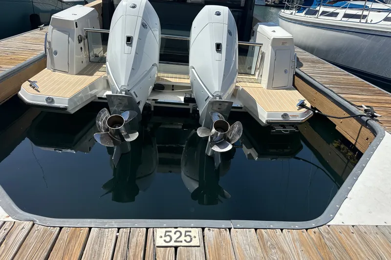 Slide: The Image of Twin outboard engines on a 2027 Saxdor 400 GTC docked at a marina. - 41
