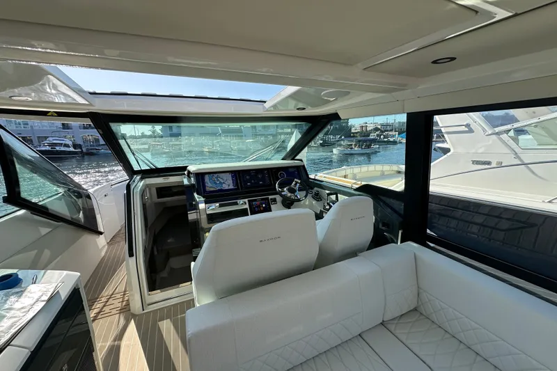 Slide: The Image of Interior view of 2027 Saxdor 400 GTC yacht with modern helm and seating. - 13