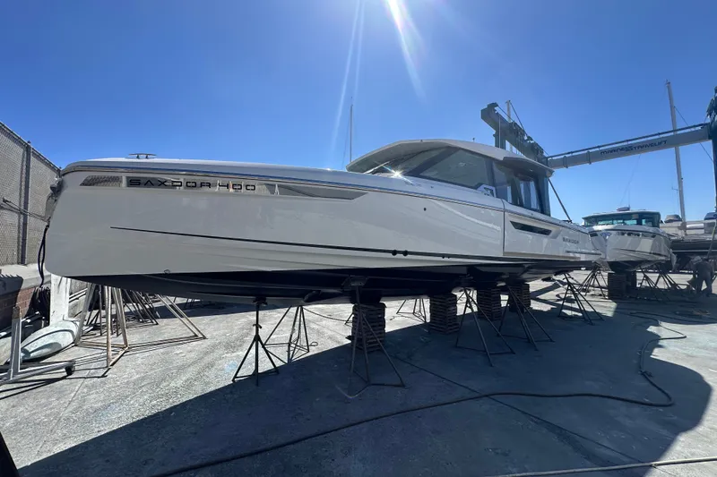 Slide: The Image of 2027 Saxdor 400 GTC boat on stands under clear blue sky. - 42