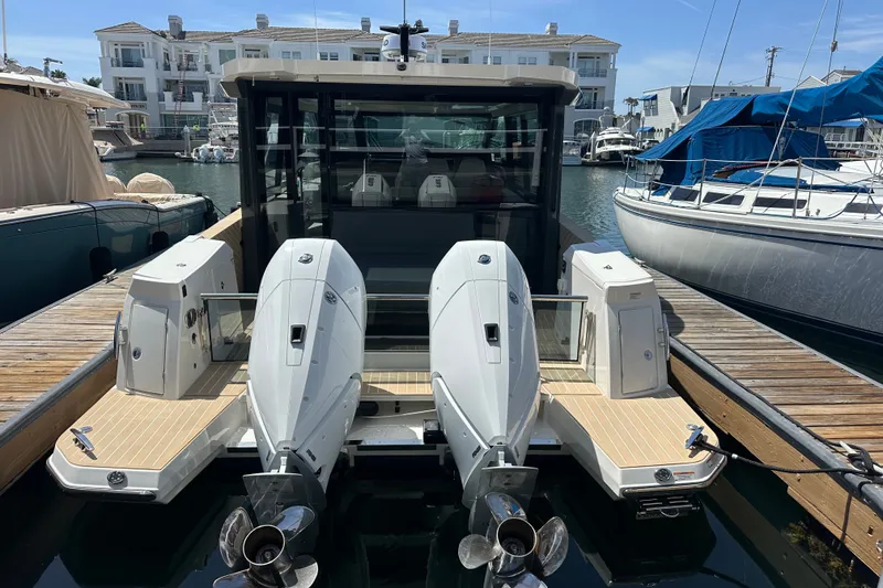 Slide: The Image of 2027 Saxdor 400 GTC boat docked, featuring dual outboard engines and modern design. - 40