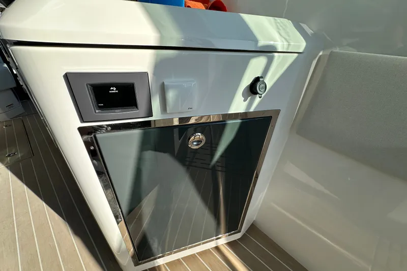 Slide: The Image of Interior view of 2027 Saxdor 400 GTC yacht, featuring a sleek control panel and storage compartment. - 27