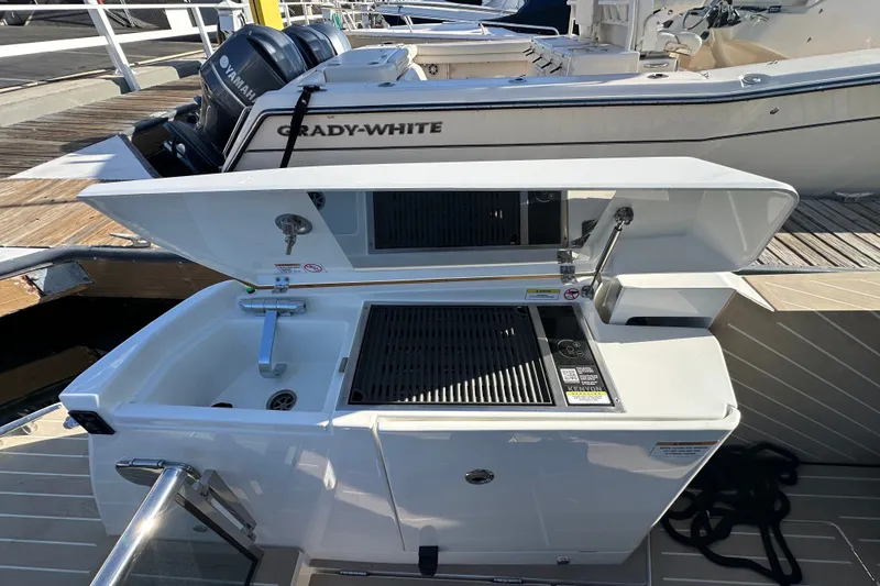 Slide: The Image of Outdoor kitchen setup on a Saxdor 400 GTC boat, featuring a sink and grill. - 37