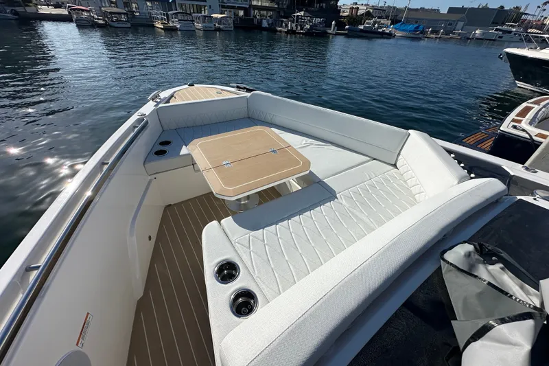 Slide: The Image of 2027 Saxdor 400 GTC boat with elegant seating and table on calm water. - 26