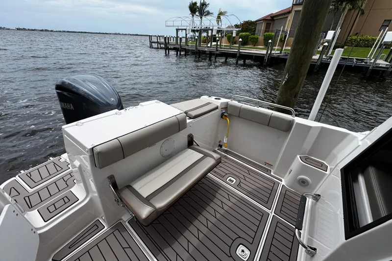 The Image of 2024 Cutwater C-248 Coupe boat deck with seating, Yamaha engine, and waterfront view. - 0
