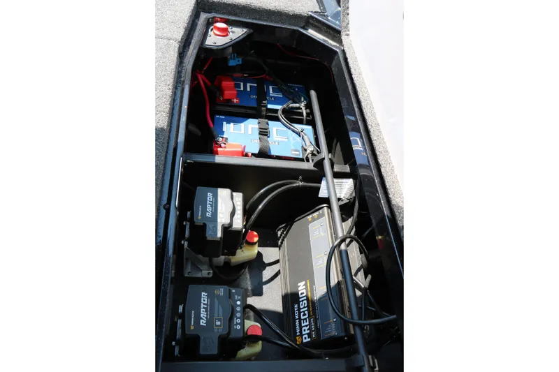 Slide: The Image of 2022 Vexus VX21 boat battery compartment with precision chargers and wiring. - 90