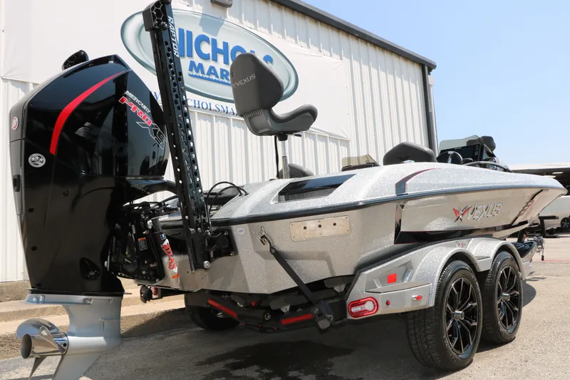 Slide: The Image of 2022 Vexus VX21 boat with powerful Mercury Pro XS engine, parked outside dealership. - 21