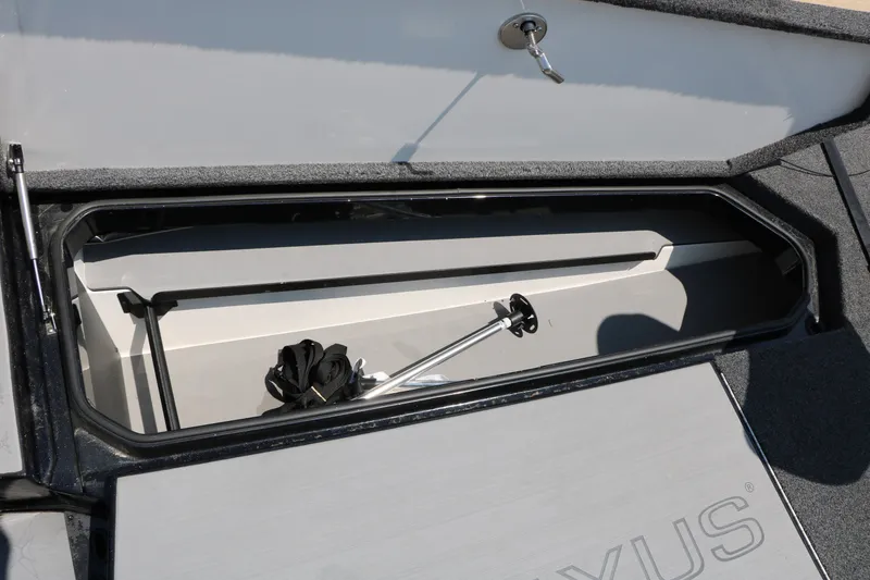 Slide: The Image of 2022 Vexus VX21 boat storage compartment with open lid and visible equipment. - 78