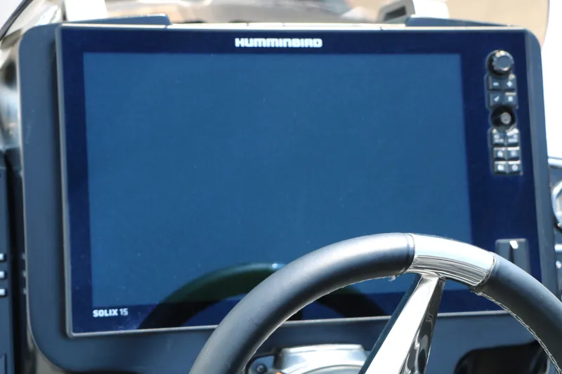 Slide: The Image of 2022 Vexus VX21 boat dashboard with Humminbird Solix 15 display and steering wheel. - 86