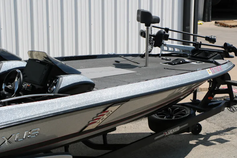 Slide: The Image of 2022 Vexus VX21 boat with sleek design, parked on a trailer near a building. - 30
