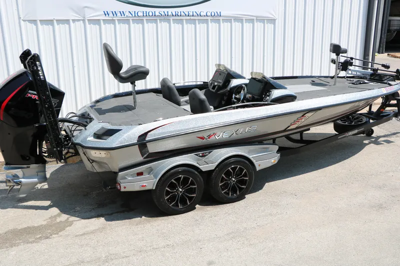Slide: The Image of 2022 Vexus VX21 boat with sleek design, dual consoles, and powerful outboard motor. - 29