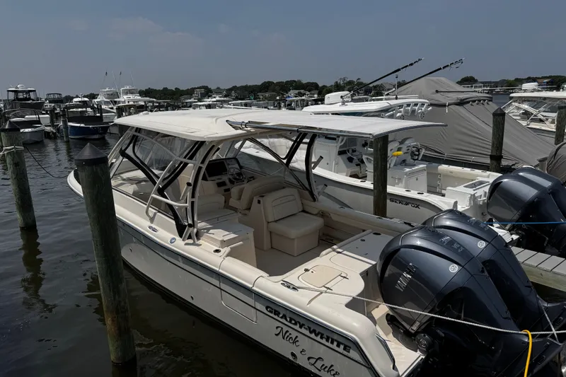 Slide: The Image of 2022 Grady-White Freedom 285 boat docked at marina with twin engines. - 4