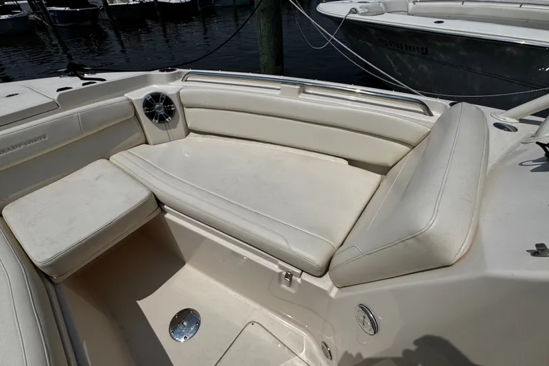 Slide: The Image of 2022 Grady-White Freedom 285 boat interior with white cushioned seating. - 12