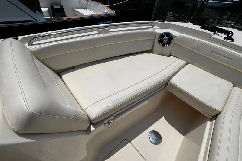 Slide: The Image of 2022 Grady-White Freedom 285 boat interior with cushioned seating and speaker. - 13