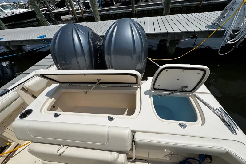 Slide: The Image of 2022 Grady-White Freedom 285 boat with open storage compartments at a marina dock. - 41