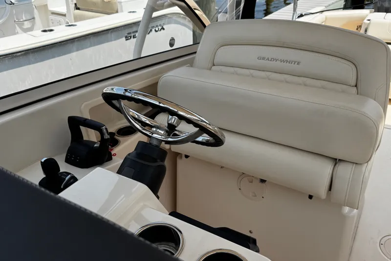 Slide: The Image of 2022 Grady-White Freedom 285 boat helm with steering wheel and controls. - 18