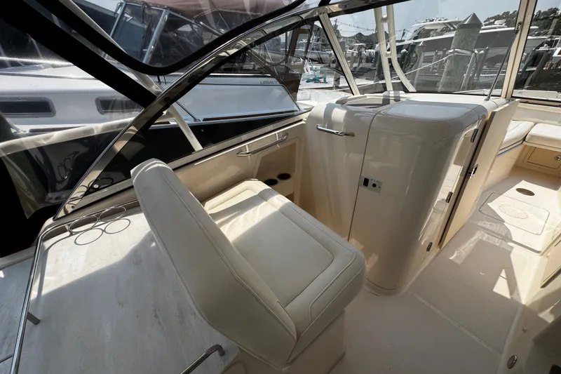 Slide: The Image of Interior of 2022 Grady-White Freedom 285 boat, featuring seating and helm area. - 21