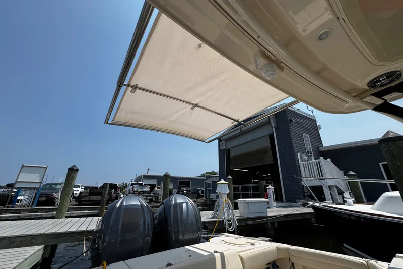 Slide: The Image of 2022 Grady-White Freedom 285 boat docked with extended canopy at marina. - 6