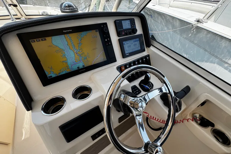 Slide: The Image of 2022 Grady-White Freedom 285 boat dashboard with navigation system and controls. - 27
