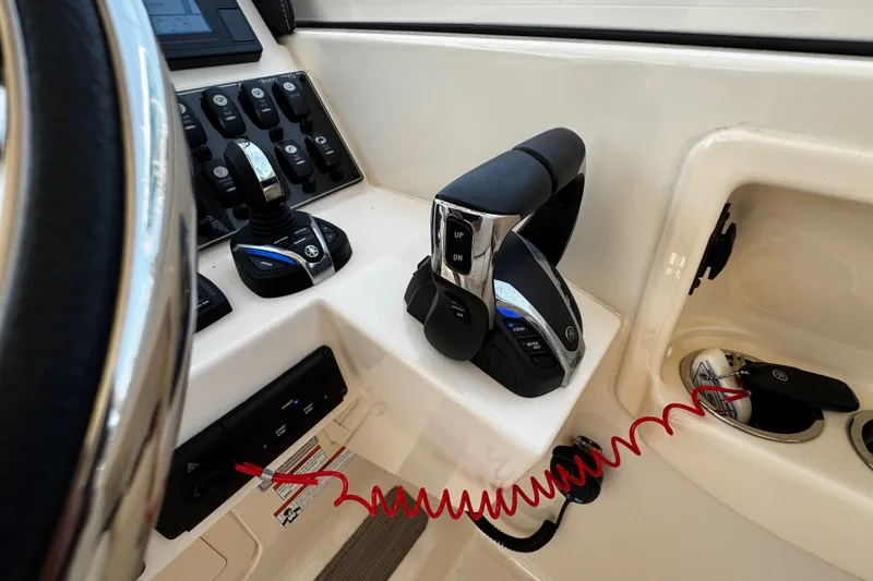 Slide: The Image of Control panel of 2022 Grady-White Freedom 285 boat with throttle and switches. - 34