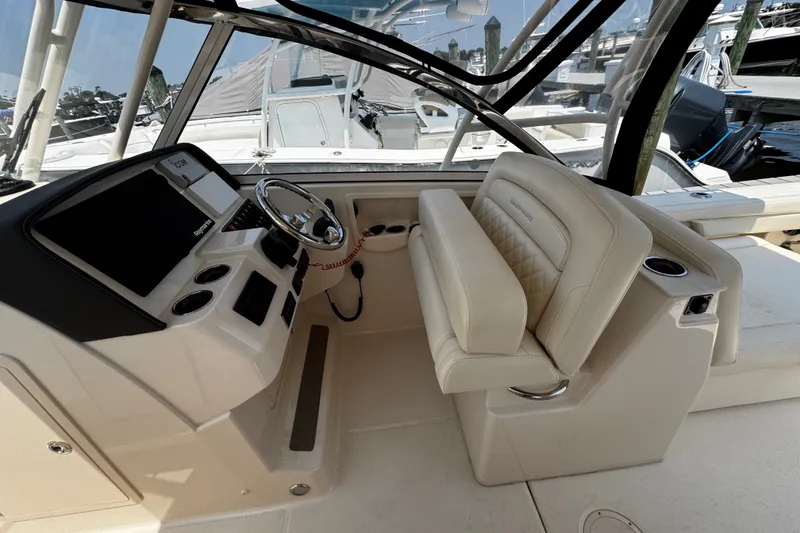 Slide: The Image of 2022 Grady-White Freedom 285 boat interior with helm and seating area. - 26