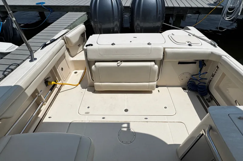Slide: The Image of 2022 Grady-White Freedom 285 boat interior with seating and storage at dock. - 40