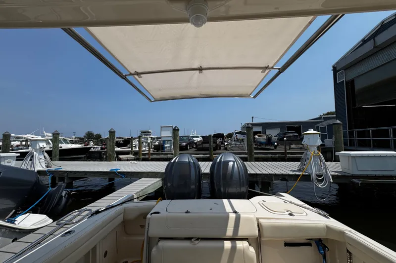 Slide: The Image of 2022 Grady-White Freedom 285 boat docked at marina with canopy overhead. - 5