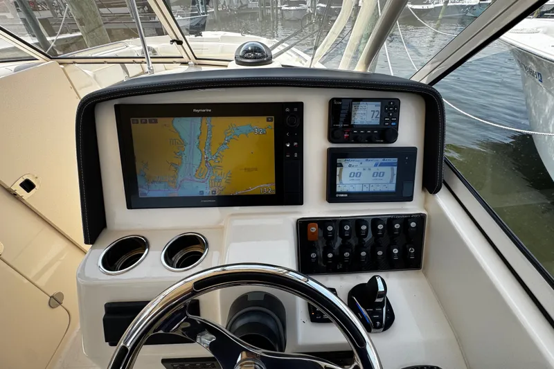Slide: The Image of 2022 Grady-White Freedom 285 boat dashboard with navigation and control systems. - 28