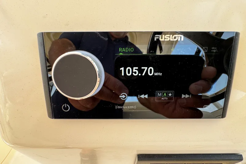 Slide: The Image of Fusion radio display on 2022 Grady-White Freedom 285, tuned to 105.70 MHz. - 37