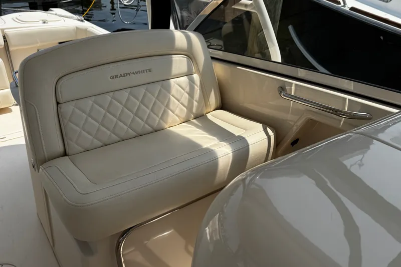 Slide: The Image of Grady-White Freedom 285 boat interior, featuring luxurious beige seating, 2022 model. - 19