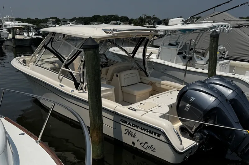 Slide: The Image of 2022 Grady-White Freedom 285 boat docked with twin Yamaha engines. - 1
