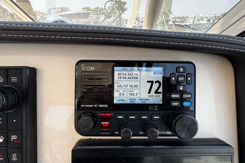 Slide: The Image of ICOM VHF marine radio on 2022 Grady-White Freedom 285 boat dashboard. - 32