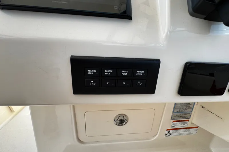 Slide: The Image of Control panel of a 2022 Grady-White Freedom 285 boat with navigation buttons. - 33