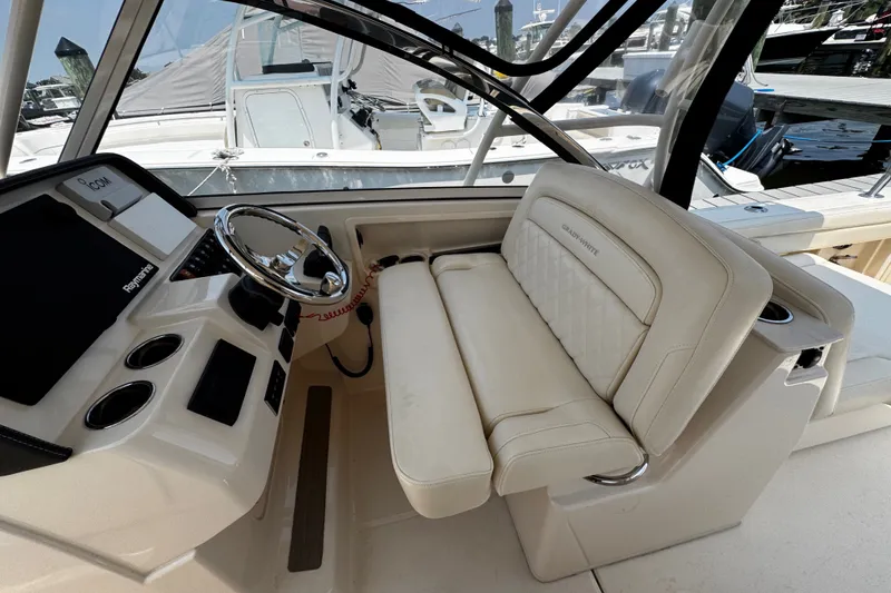 Slide: The Image of 2022 Grady-White Freedom 285 boat interior with steering wheel and plush seating. - 25