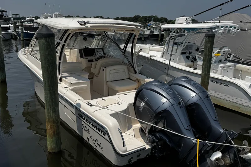 Slide: The Image of 2022 Grady-White Freedom 285 boat docked with twin Yamaha engines. - 2