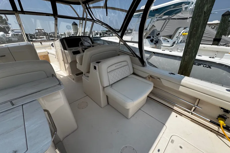 Slide: The Image of Interior of 2022 Grady-White Freedom 285 boat, featuring luxurious seating and helm station. - 23
