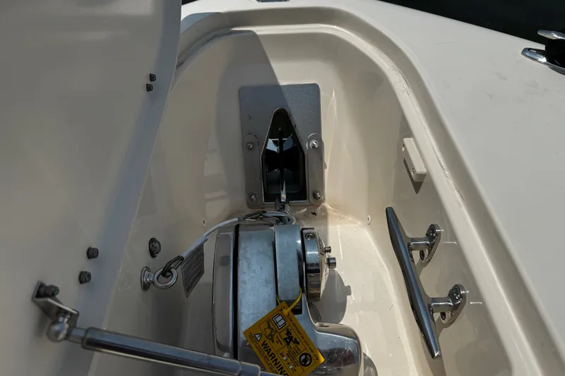 Slide: The Image of Anchor compartment of 2022 Grady-White Freedom 285 boat, featuring winch and cleat. - 7