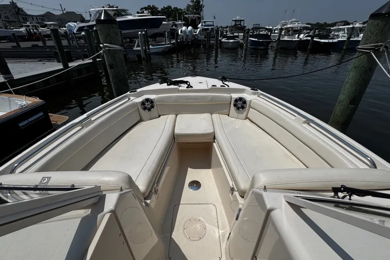 Slide: The Image of 2022 Grady-White Freedom 285 boat interior at marina, showcasing spacious seating and sleek design. - 8