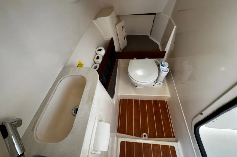 Slide: The Image of 2022 Grady-White Freedom 285 boat bathroom with sink, toilet, and wooden flooring. - 46