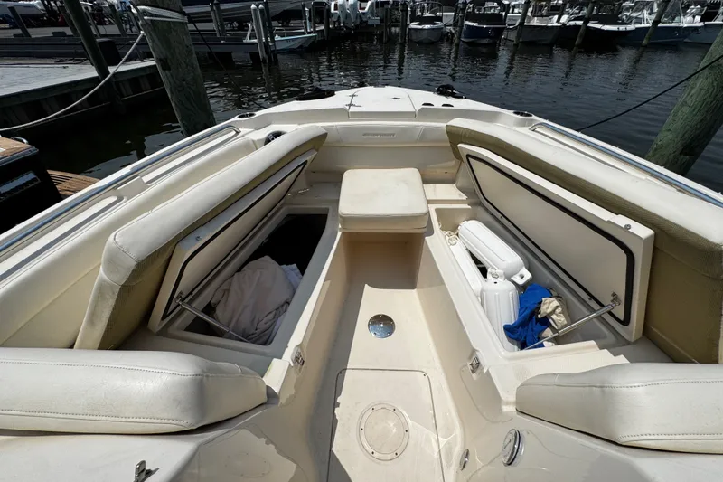 Slide: The Image of 2022 Grady-White Freedom 285 boat interior with open storage compartments at dock. - 9