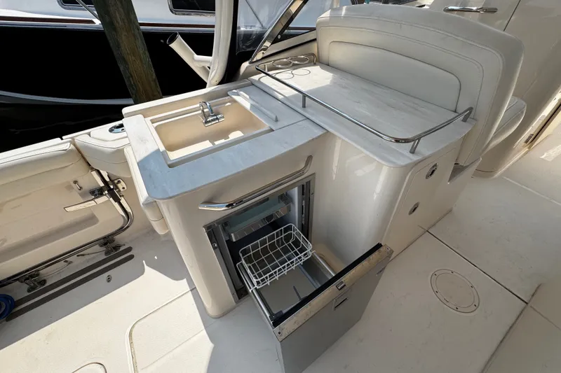 Slide: The Image of 2022 Grady-White Freedom 285 boat interior with sink and open storage compartment. - 45