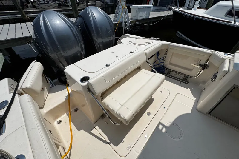 Slide: The Image of 2022 Grady-White Freedom 285 boat interior with dual engines and seating area. - 38
