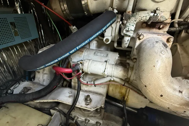 Slide: The Image of Engine compartment of a 1990 Sea Ray 420 Sundancer with marine exhaust hose. - 31